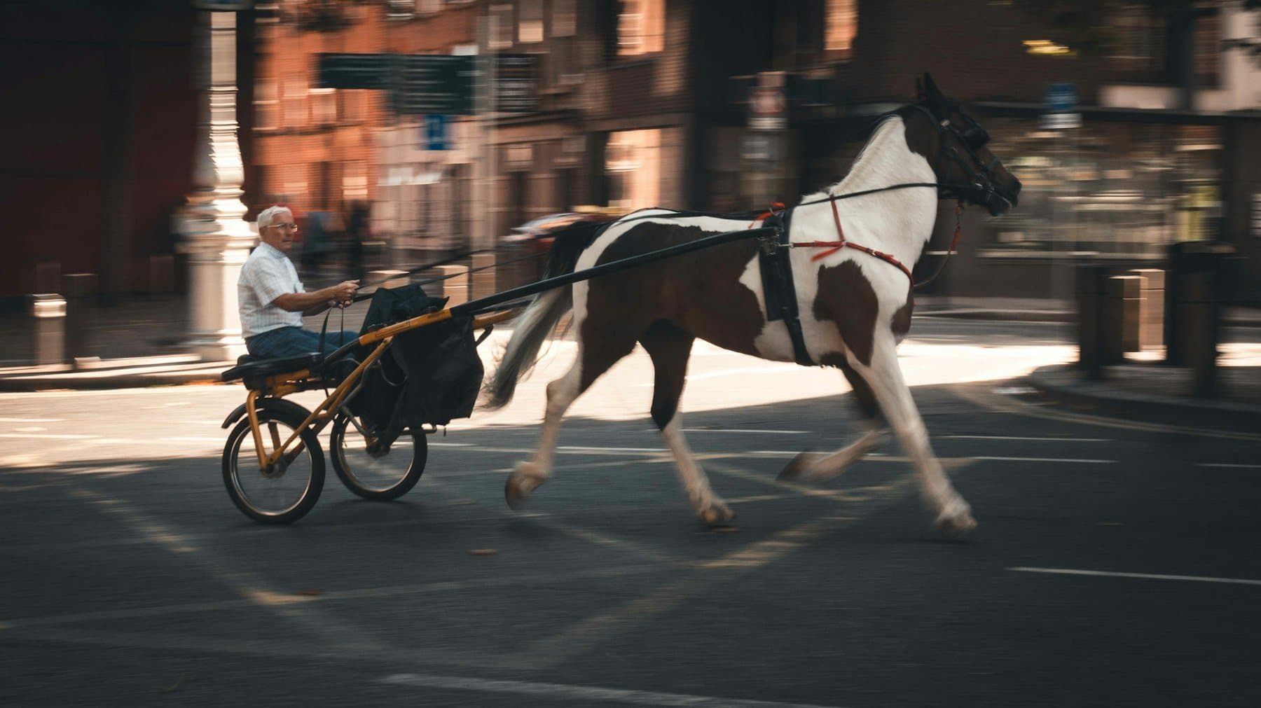 A horse and carriage moving through Dublin streets at night